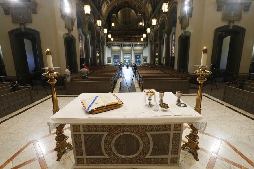 The Altar is prepped for a live streamed mass that Bishop Barry C. Knestout will conduct in an empty sanctuary at the Cathedral of the Sacred Heart Sunday April 12, 2020, in Richmond, Va. Due to Covid-19 social distancing guidelines the Catholic Church is live streaming their mass to the faithful. (AP Photo/Steve Helber) **FILE**