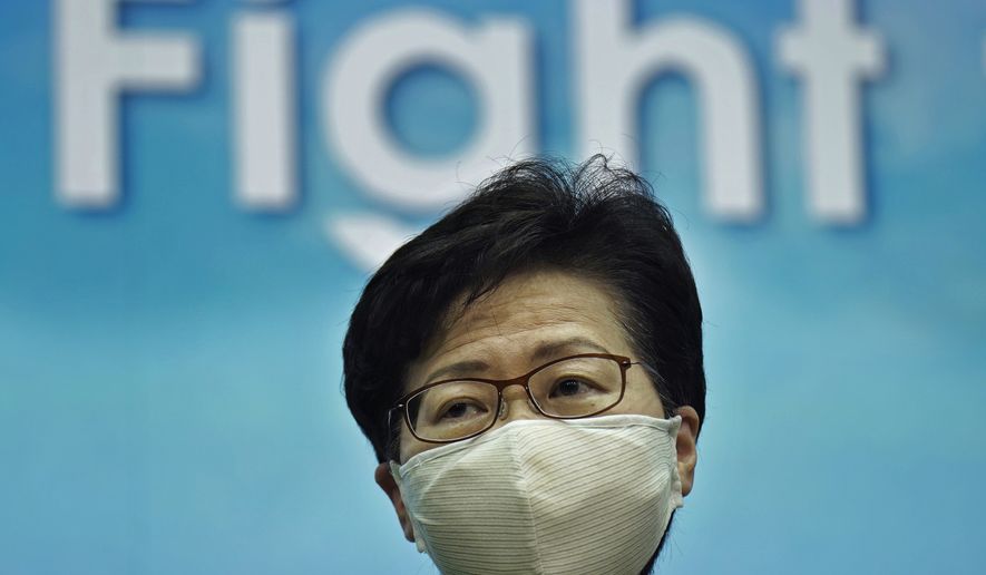 Hong Kong Chief Executive Carrie Lam listens to reporters questions during a news conference in Hong Kong, Tuesday, Aug. 18, 2020. (AP Photo/Vincent Yu)