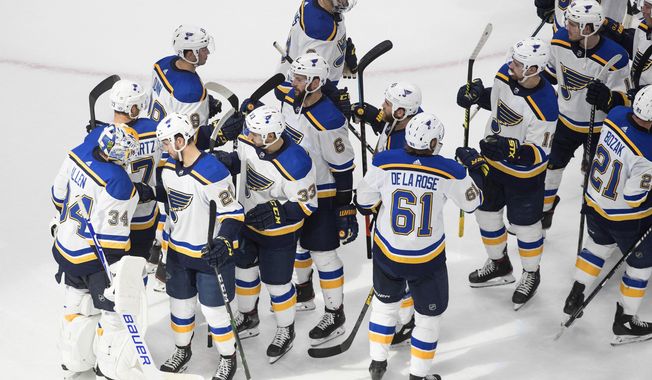 The St. Louis Blues celebrate a win over the Vancouver Canucks in Game 4 of an NHL hockey first-round playoff series, Monday, Aug. 17, 2020, in Edmonton, Alberta. (Jason Franson/The Canadian Press via AP)