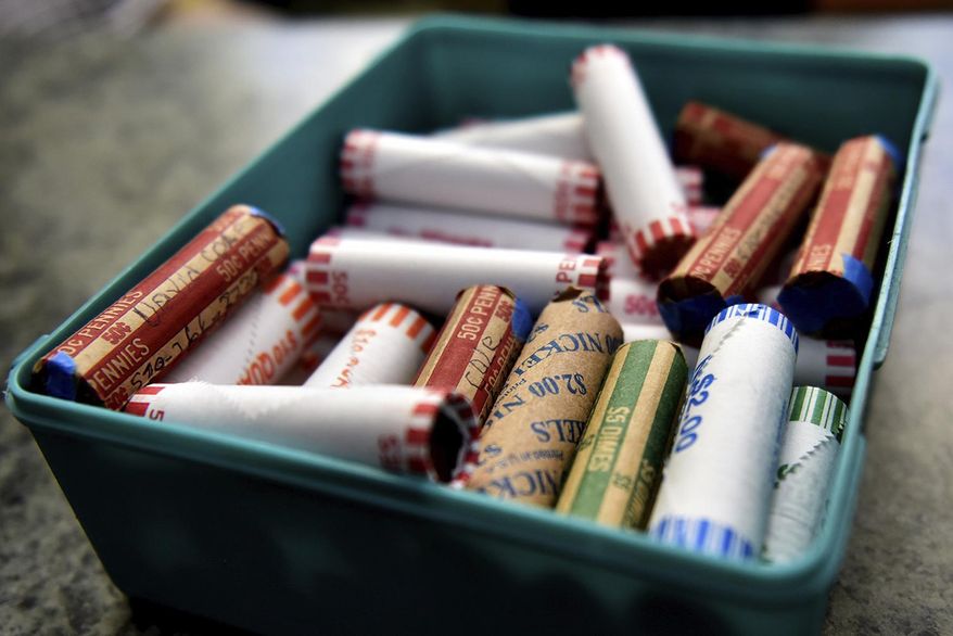 This Wednesday, July 15, 2020, file photo shows rolls of coins in a container at a market in Nanticoke, Pa. The Federal Reserve says the supply system for coins had been severely disrupted by the pandemic. While there were still enough coins out in the world, they aren’t circulating as freely because businesses have been closed and consumers weren’t spending as usual. (Sean McKeag/The Citizens' Voice via AP)