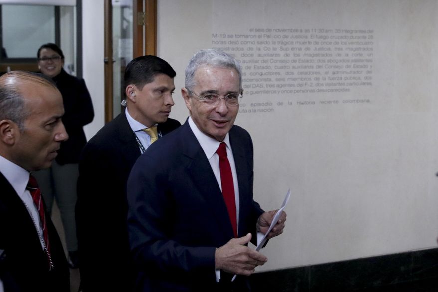 FILE - In this Oct. 8, 2019 file photo, senator and former president Alvaro Uribe arrives to the Supreme Court for questioning in an investigation for witness tampering charges in Bogota, Colombia. Uribe announced his resignation from the Senate Tuesday, Aug. 18, 2020, while he is investigated by the Supreme Court for possible witness tampering in a case that has polarized the nation. (AP Photo/Ivan Valencia, File)