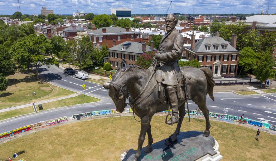 FILE - This July 10, 2020 file photo shows the statue of Confederate General Robert E. Lee is the only Confederate monument left on on Monument Avenue in Richmond, Va. A judge on Tuesday, Aug. 18, 2020 will weigh whether to dismiss a lawsuit seeking to prevent Virginia's Democratic governor from removing the statue of Lee on Monument Avenue. (AP Photo/Steve Helber)