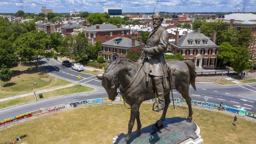 FILE - This July 10, 2020 file photo shows the statue of Confederate General Robert E. Lee is the only Confederate monument left on on Monument Avenue in Richmond, Va. A judge on Tuesday, Aug. 18, 2020 will weigh whether to dismiss a lawsuit seeking to prevent Virginia's Democratic governor from removing the statue of Lee on Monument Avenue. (AP Photo/Steve Helber)