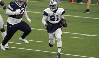 Dallas Cowboys running back Ezekiel Elliott (21) runs past defensive tackle Trysten Hill (97) during an NFL football training camp practice in Frisco, Texas, Tuesday, Aug. 18, 2020. (AP Photo/LM Otero)