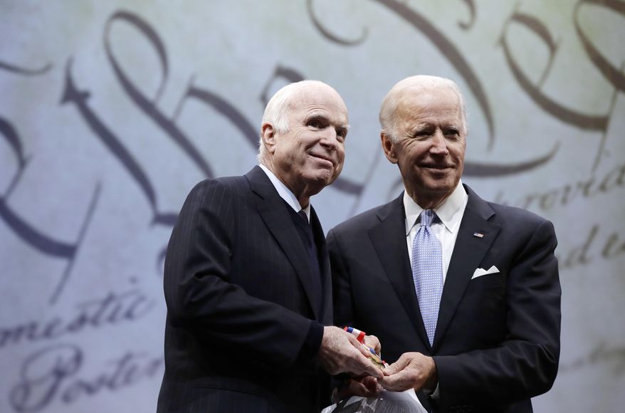 In this Oct. 16, 2017, file photo, Sen. John McCain, R-Ariz., receives the Liberty Medal from Chair of the National Constitution Center's Board of Trustees, former Vice President Joe Biden, in Philadelphia. (AP Photo/Matt Rourke, File)