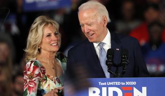FILE - In this Feb. 29, 2020 file photo, Democratic presidential candidate former Vice President Joe Biden, accompanied by his wife Jill Biden, speaks at a primary night election rally in Columbia, S.C. Jill Biden is a prankster. The wife of presumptive Democratic presidential nominee Joe Biden once sneaked into a close aide’s birthday party dressed as catering staff and surprised him with a drink.(AP Photo/Gerald Herbert)