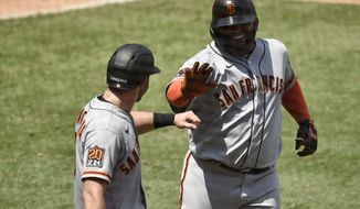San Francisco Giants designated hitter Pablo Sandoval, right, celebrates with Evan Longoria after a two-run home run during the second inning of a baseball game against the Los Angeles Angels in Anaheim, Calif., Tuesday, Aug. 18, 2020. (AP Photo/Kelvin Kuo)