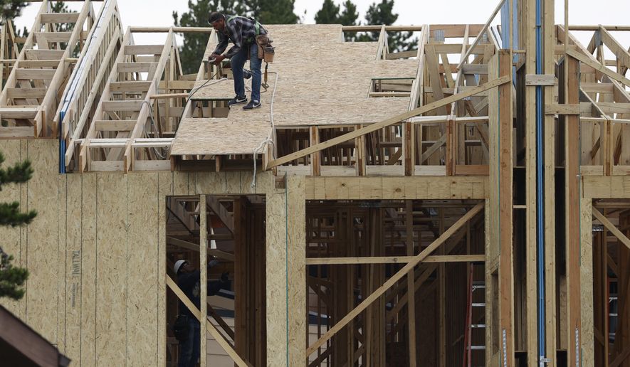 Workers toil on a multifamily dwelling Tuesday, Aug. 4, 2020, in Winter Park, Colo.   The Commerce Department reported Tuesday, Aug. 18, construction of new U.S. homes surged 22.6% last month as homebuilders continued to bounce back from the coronavirus pandemic.  (AP Photo/David Zalubowski)