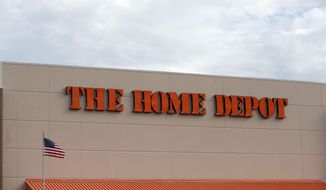 FILE - In this Aug. 27, 2019 file photo, the Home Depot logo is shown on a store in Bloomington, Minn. Home Depot’s fiscal second-quarter sales surged to easily top Wall Street’s expectations as consumers continued working on home projects and gardening amid the coronavirus outbreak.  (AP Photo/Jim Mone, File)