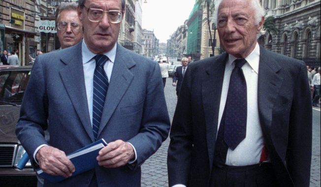 FILE -- May 31, 1988 file photo of Gianni Agnelli, right, chairman of Italy&#x27;s auto giant FIAT, and chief operating officer Cesare Romiti, as they leave the Banca d&#x27;Italia (Bankitalia)in Rome. Romiti has died Tuesday, Aug. 18, 2020, in his house in Milan at the age of 97, according to Italian media. (AP Photo/Gianni Foggia, file)