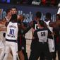 Officials separate the Dallas Mavericks and the Los Angeles Clippers after the teams got into a scuffle in Game 1 of an NBA basketball first-round playoff series, Monday, Aug. 17, 2020, in Lake Buena Vista, Fla. (Kim Klement/Pool Photo via AP)