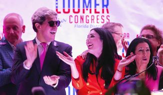 Republican congressional candidate Laura Loomer celebrates with Milo Yiannopoulos, left, and campaign director Karen Giorno, right, at an election night event at the airport Hilton in West Palm Beach, Fla., Tuesday, Aug. 18, 2020. Loomer, a far-right Republican candidate banned from social media sites because of her racist and anti-Muslim speech, won a congressional primary in Florida while embracing her role as a general election underdog in a heavily Democratic district that President Donald Trump calls home. (Allen Eyestone/The Palm Beach Post via AP)