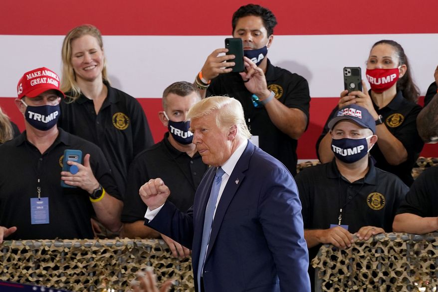 President Donald Trump pumps his fist after speaking to a crowd of supporters at the Yuma International Airport Tuesday, Aug. 18, 2020, in Yuma, Ariz. (AP Photo/Matt York)