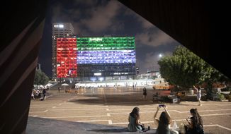 In this Thursday, Aug. 13, 2020, file photo, the Tel Aviv City Hall is lit up with the flag of the United Arab Emirates as Israel and the UAE announced they would be establishing full diplomatic ties, in Tel Aviv, Israel. (AP Photo/Oded Balilty, File)