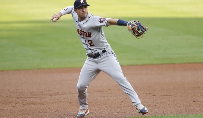 Houston Astros third baseman Alex Bregman throws to first base to put out Colorado Rockies&#x27; Trevor Story in the first inning of a baseball game Wednesday, Aug. 19, 2020, in Denver. (AP Photo/David Zalubowski)