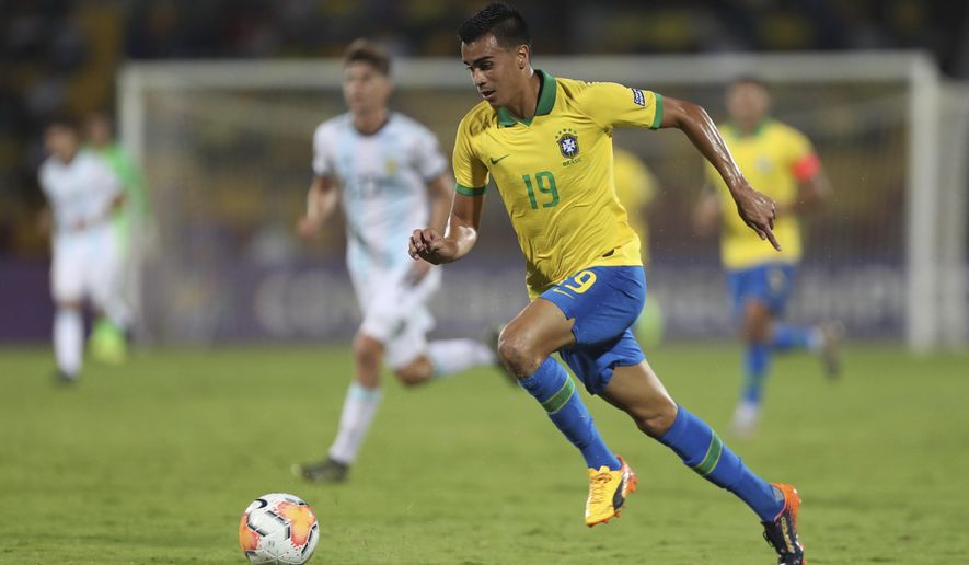 Brazil's Reinier dribbles the ball upfield during a South America Olympic qualifying U23 soccer match against Argentina at the Alfonso Lopez stadium in Bucaramanga, Colombia, Sunday, Feb. 9, 2020. (AP Photo/Fernando Vergara)