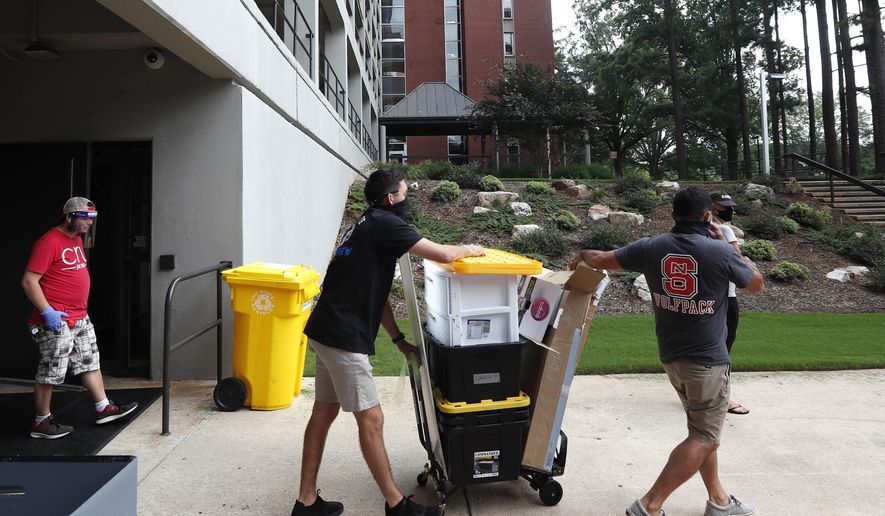 FILE - In this July 31, 2020, file photo, college students begin moving in for the fall semester at N.C. State University in Raleigh, N.C.  Colleges are eager to share their reopening plans as they encourage students to return to campus. But fewer of them are talking about the elephant in the room: what happens if they need to shut down again.(AP Photo/Gerry Broome, File)