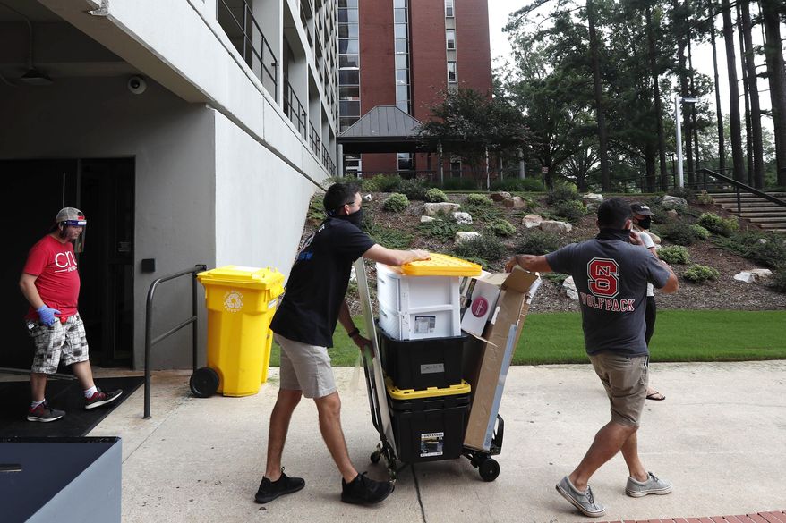 FILE - In this July 31, 2020, file photo, college students begin moving in for the fall semester at N.C. State University in Raleigh, N.C. Colleges are eager to share their reopening plans as they encourage students to return to campus. But fewer of them are talking about the elephant in the room: what happens if they need to shut down again.(AP Photo/Gerry Broome, File)
