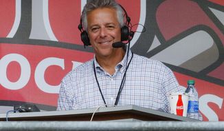 FILE - In this Sept. 25, 2019, file photo, Cincinnati Reds broadcaster Thom Brennaman sits in a special outside booth before the Reds&#39; baseball game against the Milwaukee Brewers in Cincinnati. Brennaman used a gay slur during the broadcast of Cincinnati&#39;s game against the Kansas City Royals on Wednesday, Aug. 19, 2020. Brennaman used the slur moments after the Fox Sports Ohio broadcast returned from a commercial break before the seventh inning in the first game of a doubleheader. Brennaman did not seem to realize he was already on air. (AP Photo/John Minchillo, File)