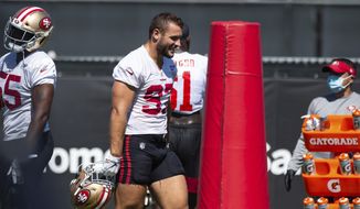 San Francisco 49ers defensive end Nick Bosa (97) walks in beat to the music during NFL Training Camp practice Saturday, Aug. 15, 2020, at the SAP Performance Facility in Santa Clara, Calif. (Xavier Mascarenas/The Sacramento Bee via AP)