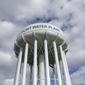 FILE - In this March 21, 2016, file photo, the Flint Water Plant water tower is seen in Flint, Mich. Michigan Gov. Gretchen Whitmer says a proposed $600 million deal between the state of Michigan and Flint residents harmed by lead-tainted water is a step toward making amends. Officials announced the settlement Thursday, Aug. 20, 2020, which must be approved by a federal judge. (AP Photo/Carlos Osorio, File)