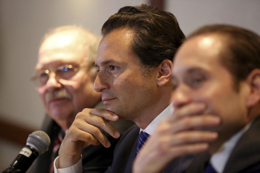 FILE - In this Aug. 17, 2017 file photo, flanked by his lawyers, Emilio Lozoya, former head of Mexico&#39;s state-owned oil company Pemex, attends a press conference in Mexico City. The alleged examples of kickbacks, bribes and graft contained in accusations by Lozoya on Wednesday, Aug. 20, 2020, include that one government contractor gave then-President Enrique Pena Nieto a Ferrari sports car. (AP Photo/Gustavo Martinez Contreras, File)