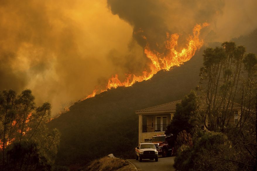 FILE - In this Monday, Aug. 17, 2020 file photo, flames from the River Fire crest a ridge in Salinas, Calif. In California, a Mediterranean climate sets up ideal conditions for fire then is worsened by climate change, says University of California, Merced, fire scientist LeRoy Westerling, who has had his home threatened twice in the last few years. (AP Photo/Noah Berger)