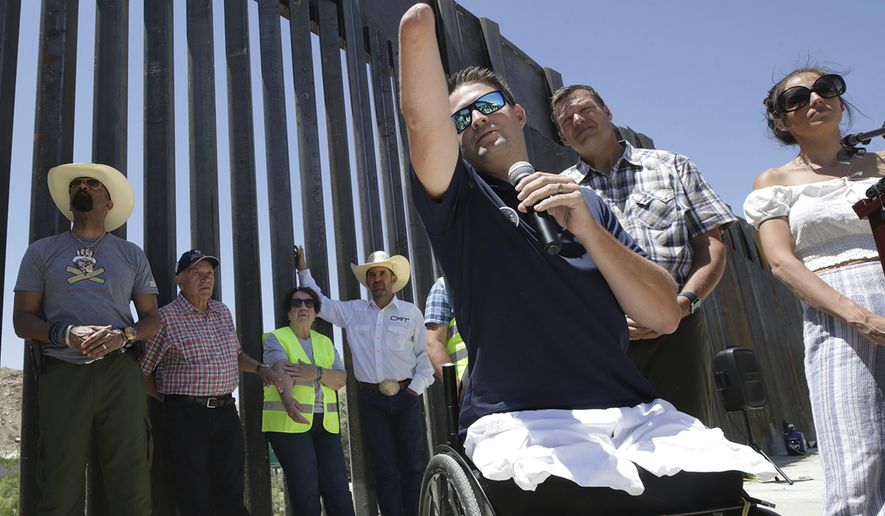 In this May 30, 2019 file photo, Brian Kolfage, founder of We Build the Wall Inc., speaks at a news conference in Sunland Park, N.M., where a privately funded wall is being constructed. Former White House adviser Steve Bannon was arrested Thursday, Aug. 20, 2020, on charges that he and three others, including Kolfage, ripped off donors to the online fundraising scheme “We Build The Wall.”  (Mark Lambie/The El Paso Times via AP, File)