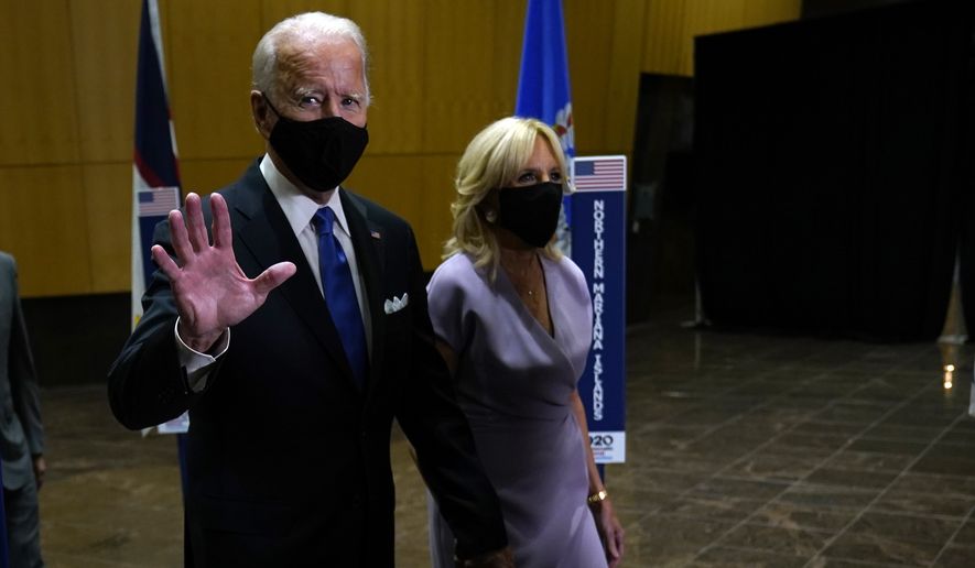 Democratic presidential candidate former Vice President Joe Biden walks to an outdoor stage with his wife Jill Biden during the fourth day of the Democratic National Convention, Thursday, Aug. 20, 2020, at the Chase Center in Wilmington, Del. (AP Photo/Andrew Harnik)