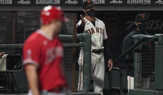 San Francisco Giants manager Gabe Kapler gestures toward umpires as Los Angeles Angels&#39; Mike Trout, left, stands at the plate during the seventh inning of a baseball game in San Francisco, Thursday, Aug. 20, 2020. (AP Photo/Jeff Chiu)