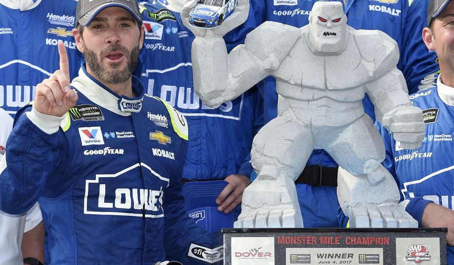 FILE - In this June 4, 2017, file photo, Jimmie Johnson, left, poses with the trophy in Victory Lane after he won a NASCAR Cup series auto race at Dover International Speedway in Dover, Del. Jimmie Johnson has a track-record 11 wins at Dover International Speedway. He’ll have to win No. 12 to guarantee a playoff spot and he has two shots this weekend when the NASCAR Cup series races on Saturday and Sunday. (AP Photo/Nick Wass, File)