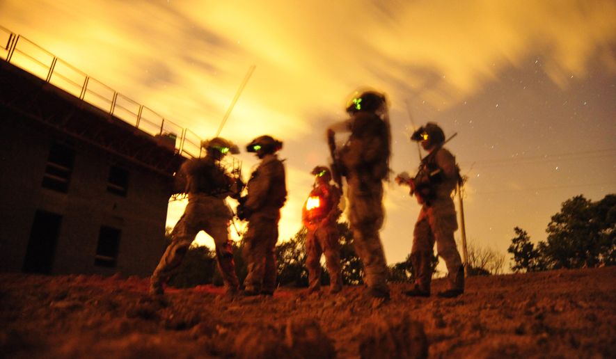 In this 2012 photo made available by the U.S. Navy, a squad of Navy SEALs participate in special operations urban combat training at an undisclosed location. In 2019, the Foxtrot platoon of SEAL Team 7, known as Trident 1726, was sent home early after an alleged sexual assault and drinking at a Fourth of July barbecue in Iraq in 2019 in violation of Navy rules barring deployed troops from consuming alcohol. (Petty Officer 2nd Class Meranda Keller/U.S. Navy via AP)