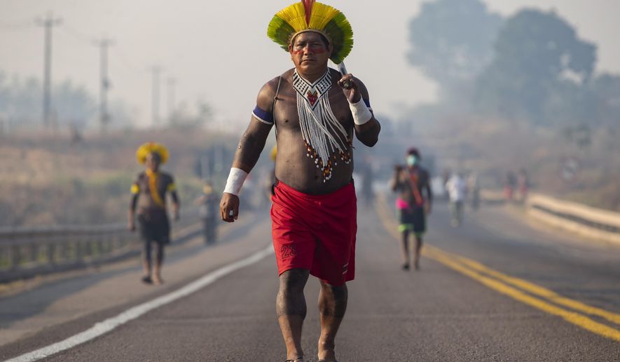 Kayapo Indigenous block a highway near Novo Progresso, Para state, Brazil, Monday, Aug. 17, 2020. Protesters blocked the highway BR-163 to pressure Brazilian President Jair Bolsonaro to better shield them from COVID-19, to extend damages payments for road construction near their land, and to consult them on a proposed railway to transport soybeans and corn. (AP Photo/Andre Penner)