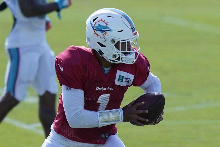 Miami Dolphins quarterback Tua Tagovailoa (1) runs drills during practice at the NFL football team's training facility, Friday, Aug. 21, 2020, in Davie, Fla. Miami Dolphins quarterback Ryan Fitzpatrick is missing practice for personal reasons. Fitzpatrick's absence left top draft pick Tagovailoa and quarterback Josh Rosen to take snaps Friday. (AP Photo/Lynne Sladky)