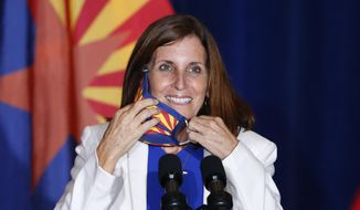 FILE - In this Tuesday, Aug. 11, 2020 file photo, Sen. Martha McSally, R-Ariz., smiles as she removes her face covering to speak prior to Vice President Mike Pence arriving to speak at the &amp;quot;Latter-Day Saints for Trump&amp;quot; coalition launch event in Mesa, Ariz. McSally has suggested that supporters could “fast a meal&amp;quot; to donate to the Arizona Republican&#39;s campaign as she fights to fend off a tough challenge from Democrat Mark Kelly in the November 2020 election. (AP Photo/Ross D. Franklin)