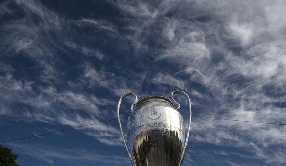 A giant replica of the UEFA Champions League trophy is displayed at the Rossio square downtown Lisbon, Portugal, Friday, Aug. 21, 2020. PSG will play Bayern in the Champions League final on Sunday. (AP Photo/Manu Fernandez)