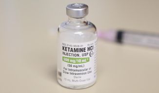 FILE - In this July 25, 2018, file photo, is a vial of ketamine, which is normally stored in a locked cabinet, in Chicago. A drug called ketamine that&#39;s injected as a sedative during arrests has drawn new scrutiny since a young Black man named Elijah McClain died in suburban Denver. An analysis by The Associated Press of policies on ketamine and cases where it was used nationwide uncovered a lack of police training, conflicting medical standards and nonexistent protocols that have resulted in hospitalizations and even deaths. (AP Photo/Teresa Crawford, File)