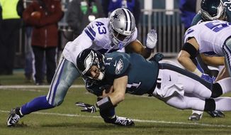 FILE - In this Dec. 22, 2019, file photo, Dallas Cowboys&#39; Malcolm Smith (43) tackles Philadelphia Eagles&#39; Carson Wentz during the second half of an NFL football game in Philadelphia. Thin and inexperienced at linebacker, the Cleveland Browns signed former Super Bowl MVP Smith on Sunday, Aug. 23, 2020. (AP Photo/Chris Szagola, File)