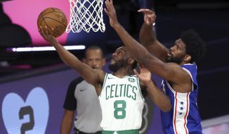 Boston Celtics guard Kemba Walker (8) shoots past Philadelphia 76ers center Joel Embiid, right, during the first quarter of Game 4 of an NBA basketball first-round playoff series, Sunday, Aug. 23, 2020, in Lake Buena Vista, Fla. (Kim Klement/Pool Photo via AP)