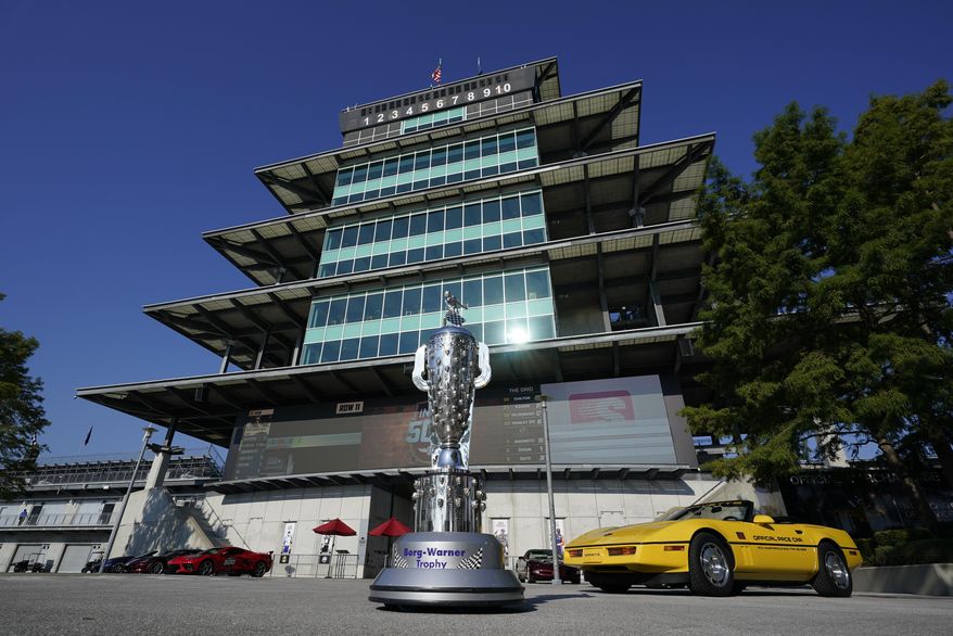 The Borg-Warner Trophy complete with a checkered flag mask, is displayed outside of the Pagoda before the Indianapolis 500 auto race at Indianapolis Motor Speedway, Sunday, Aug. 23, 2020, in Indianapolis.(AP Photo/Darron Cummings)