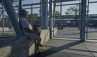 Barney Colborn sits outside of the main gate before the Indianapolis 500 auto race at Indianapolis Motor Speedway, Sunday, Aug. 23, 2020, in Indianapolis. The race is being held without fans. (AP Photo/Darron Cummings)
