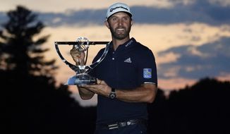 Dustin Johnson holds the trophy after winning the Northern Trust golf tournament at TPC Boston, Sunday, Aug. 23, 2020, in Norton, Mass. (AP Photo/Charles Krupa)