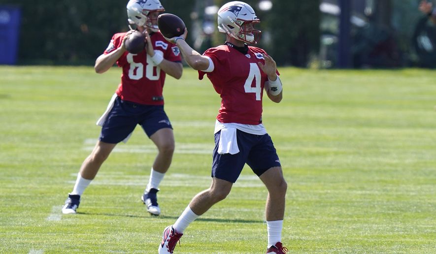New England Patriots quarterbacks Brian Lewerke (68) and Jarrett Stidham (4) warm up during an NFL football training camp practice, Sunday, Aug. 23, 2020, in Foxborough, Mass. (AP Photo/Steven Senne, Pool)