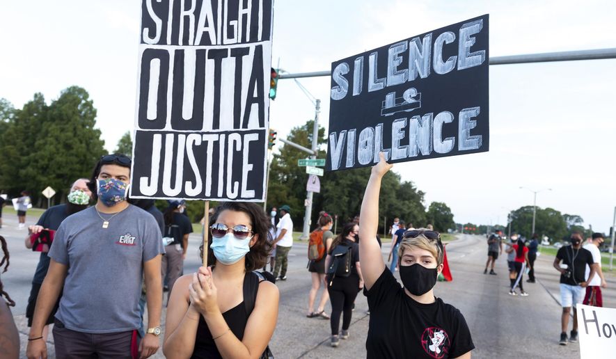 Protesters take to the street and block traffic at the intersection of Willow Street and Evangeline Thruway after a vigil held Saturday, Aug. 22, 2020, in Lafayette, La., for 31-year-old Trayford Pellerin, who was shot and killed by Lafayette police officers while armed with a knife the night before. (Scott Clause/The Daily Advertiser via AP)