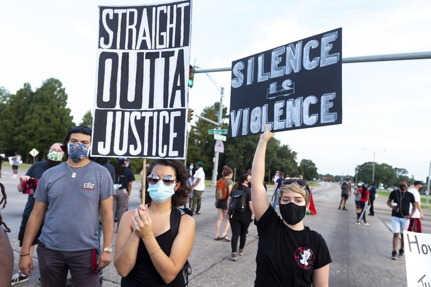 Protesters take to the street and block traffic at the intersection of Willow Street and Evangeline Thruway after a vigil held Saturday, Aug. 22, 2020, in Lafayette, La., for 31-year-old Trayford Pellerin, who was shot and killed by Lafayette police officers while armed with a knife the night before. (Scott Clause/The Daily Advertiser via AP)