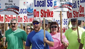 FILE - In this July 25, 2020 file photo, striking Bath Iron Works shipbuilders march in solidarity in Bath, Maine. A 63-day strike at Bath Iron Works — against the backdrop of a pandemic in an election year — came to an end Sunday, Aug. 23 with shipbuilders voting to return to their jobs producing warships for the United States Navy. (AP Photo/Robert F. Bukaty, File)