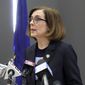 In this March 16, 2020, file photo, Oregon Gov. Kate Brown speaks at a news conference in Portland, Ore., to announce a four-week ban on eat-in dining at bars and restaurants, due to COVID-19, throughout the state. As she was putting the finishing touches on a reopening plan in May, Oregon Gov. Kate Brown received a letter from a coalition of business groups pressing for more say in the process. (AP Photo/Gillian Flaccus, File)