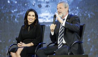 This Wednesday, Nov. 28, 2018, file photo shows the Rev. Jerry Falwell Jr., right, and his wife during after a town hall at a convocation at Liberty University in Lynchburg, Va. Falwell Jr. says he is seeking help for the &quot;emotional toll&quot; from an affair his wife had with a man who he says later threatened his family. (AP Photo/Steve Helber)