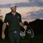 Dustin Johnson carries the trophy after winning the Northern Trust golf tournament at TPC Boston, Sunday, Aug. 23, 2020, in Norton, Mass. (AP Photo/Charles Krupa)  **FILE**