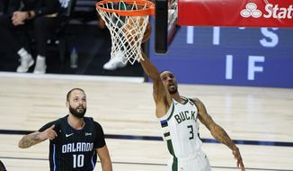 Milwaukee Bucks&#39; George Hill (3) drives to the basket past Orlando Magic&#39;s Evan Fournier (10) during the second half of an NBA basketball first round playoff game Monday, Aug. 24, 2020, in Lake Buena Vista, Fla. (AP Photo/Ashley Landis, Pool)